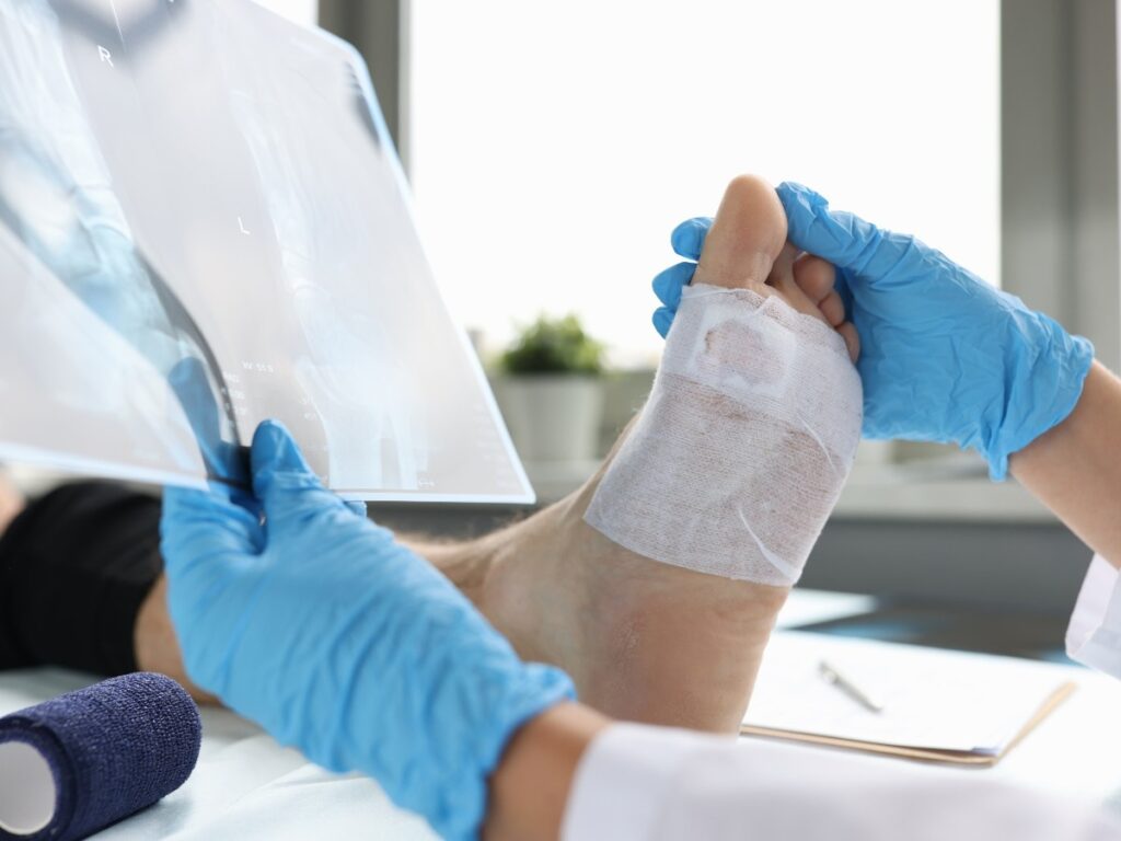A diabetic wound care doctor Houston reviewing a detailed report of a diabetic patient’s foot wound.
