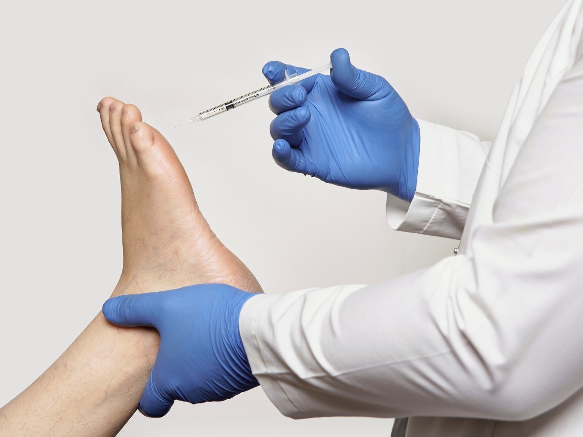 A DPM injecting a patient for foot pain relief in Cornerstone Village North.