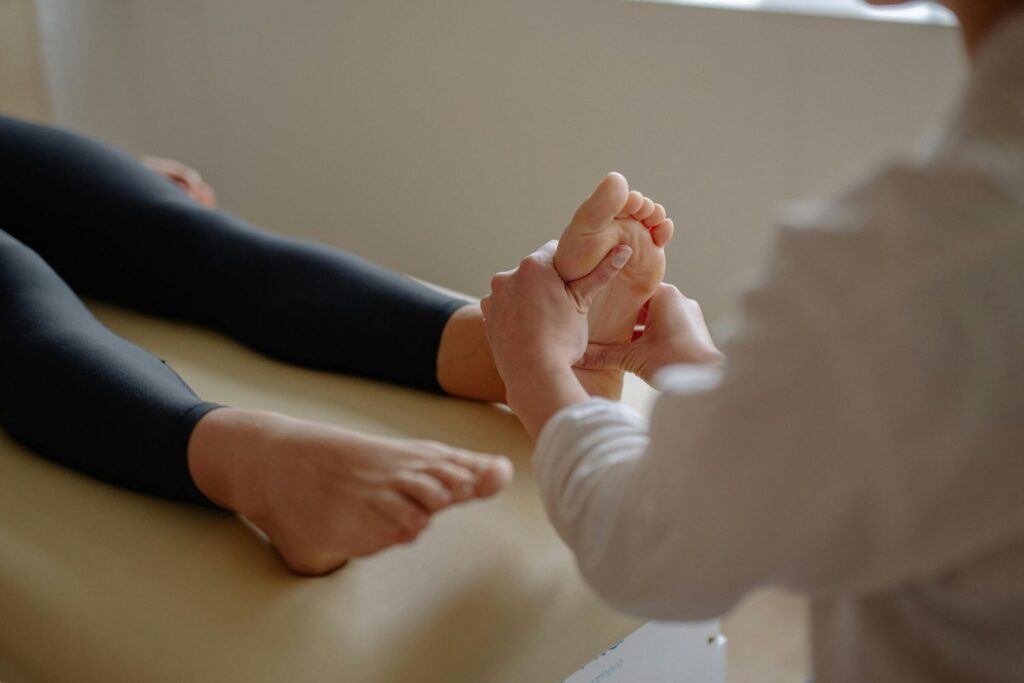 A doctor examines a patient's foot, offering comprehensive care at urgent care for ankle sprain in Houston.