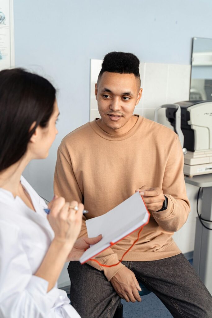 A doctor discusses treatment options with a patient, demonstrating the convenience of a same-day podiatrist in Houston.