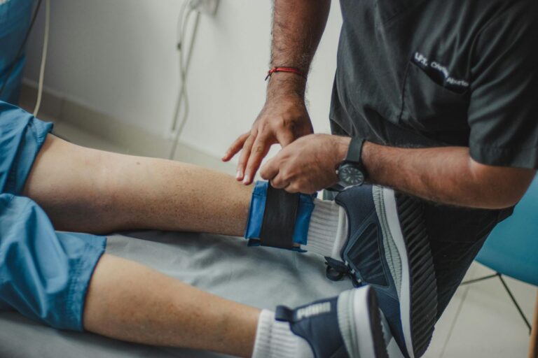 A medical professional applies a diagnostic strap to a patient's foot, a warning sign that requires a same-day podiatrist in Houston