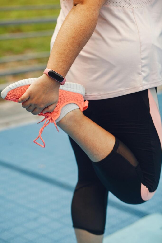 A runner performs a heel stretch, a preventative measure for a condition that may require urgent care for heel pain in Houston