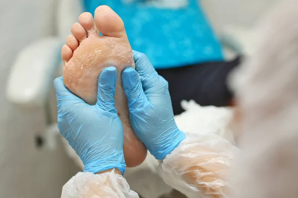 Podiatrist examining foot with Friday Health Plan coverage in Cypress, addressing "What Foot Conditions Need To Be Referred To The Podiatrist?" blog topic.