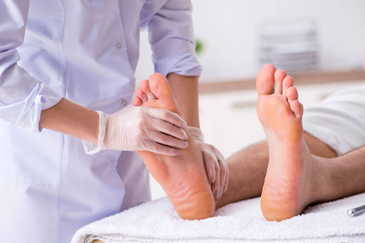 Leneva podiatrist checking patient’s foot pain condition before treatment