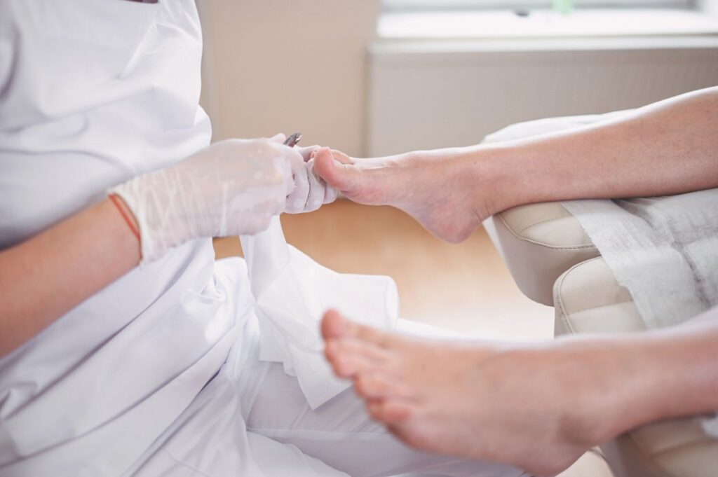 Podiatrist ingrown toenail treatment performed in clean spa setting with professional care and hygienic nail tools.