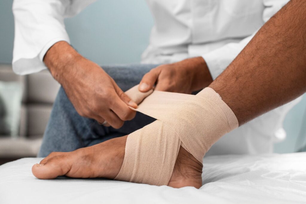 Doctor bandaging a patient’s ankle, provided by a Foot and Ankle Doctor Houston for expert treatment.