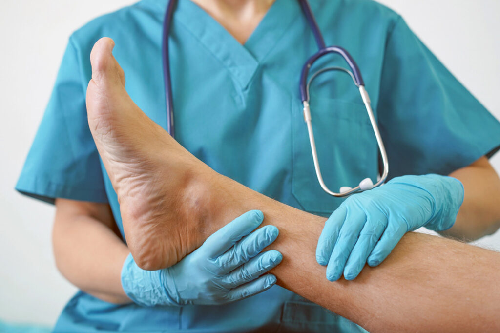 blue cross blue shield podiatrist houston checking patient’s leg and foot circulation during podiatry exam in medical office