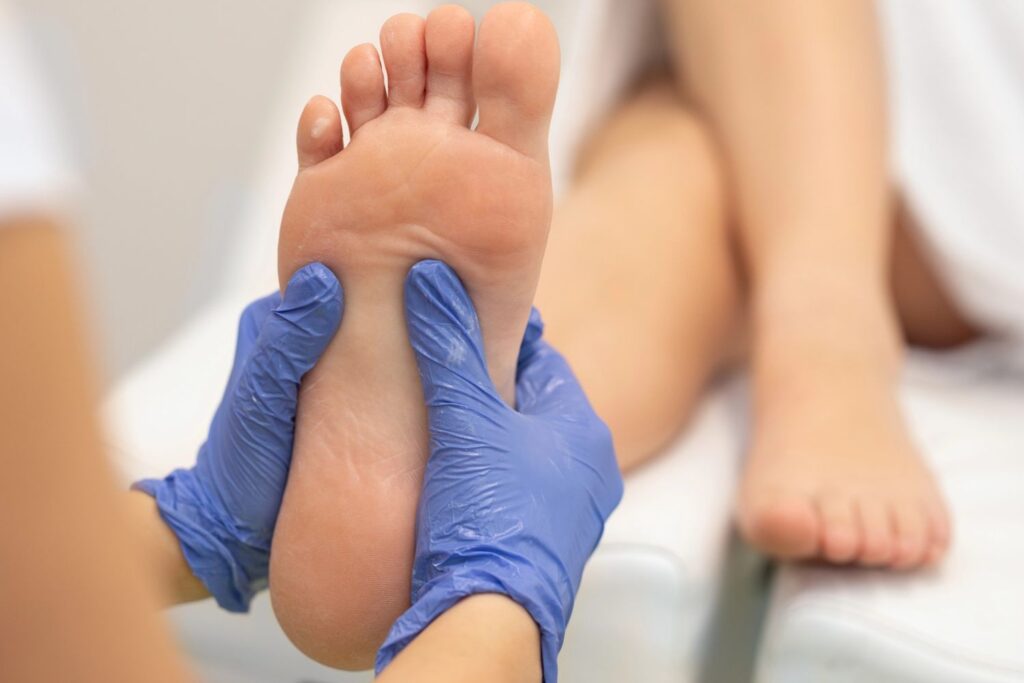 Specialist examining a patient's foot to see if the QUTENZA treatment Houston offers is right for their nerve pain.