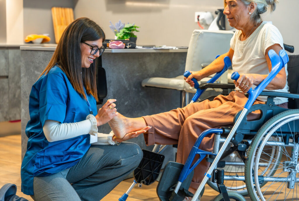 Compassionate podiatrist Cypress provider assisting a senior patient with foot rehabilitation and recovery care.