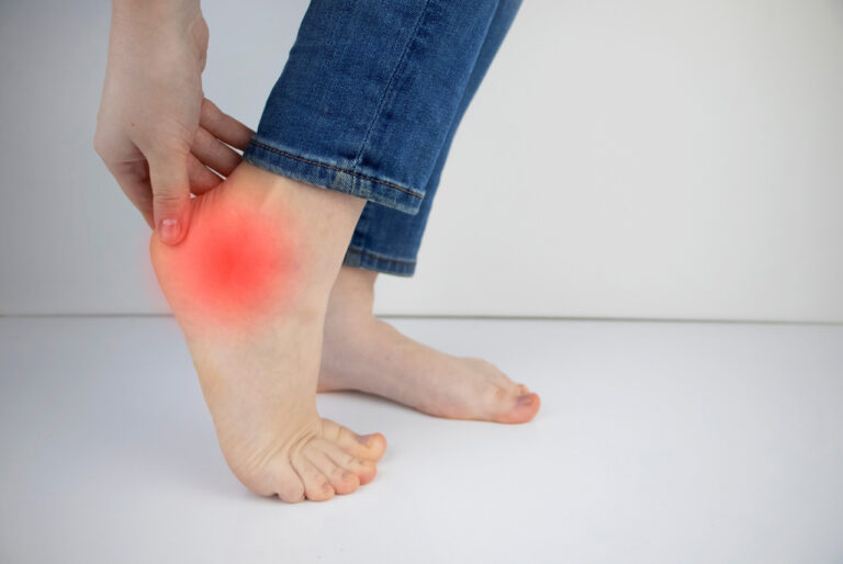 Patient seeking a heel pain doctor Cypress for relief from sharp stinging pain in the back of the heel and ankle.