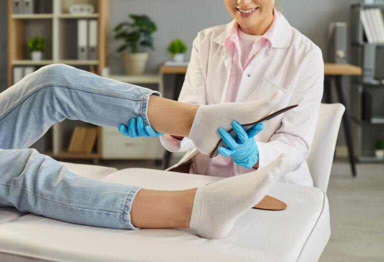Patient receiving an orthotics fitting from a friendly Walk In Podiatrist Cypress to improve foot health and gait.