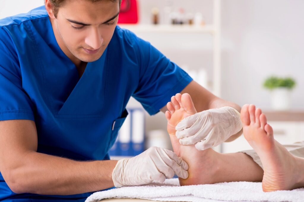 Medical exam by a Blue Cross Blue Shield podiatrist Cypress expert checking a patient's foot health in a modern clinic.