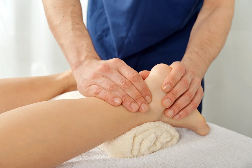 Experienced Blue Cross Blue Shield podiatrist Cypress specialist performing a therapeutic ankle massage for pain relief.