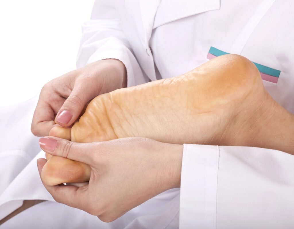 Expert bunion treatment doctors Cypress performing a physical foot examination to assess joint misalignment.