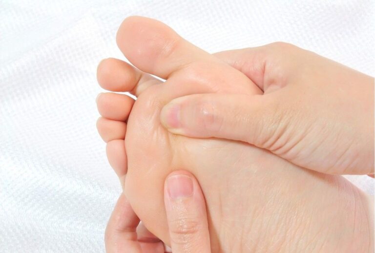 Superior HealthPlan podiatrist Cypress patients can practice foot pain relief with this self-massage technique, shown on a white towel.