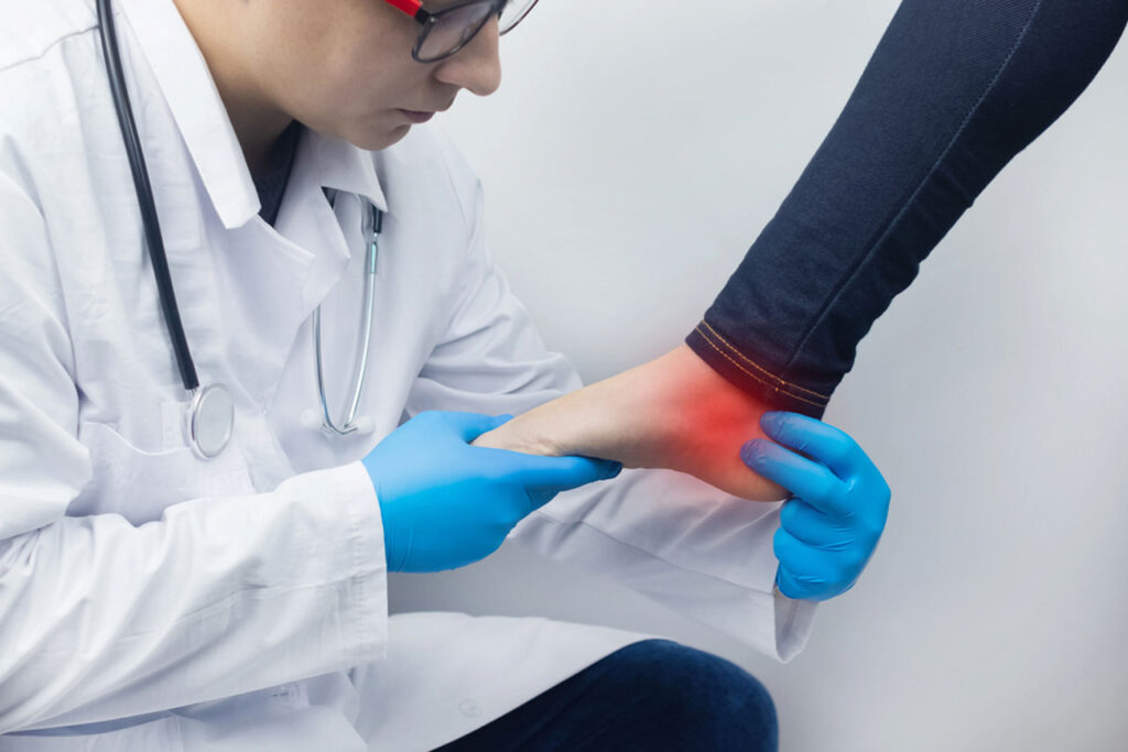 A detailed examination of a patient's sore heel by an expert heel pain doctor Cypress in a medical office.